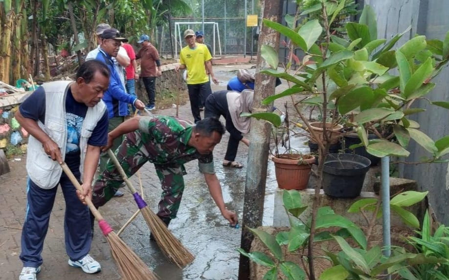 Gunakan Gagang Sapu, Babinsa dan Warga Bersihkan Lingkungan